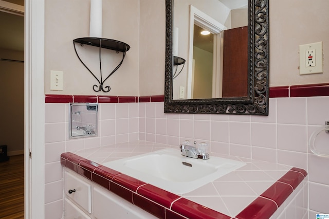 bathroom with hardwood / wood-style flooring, tasteful backsplash, vanity, and tile walls