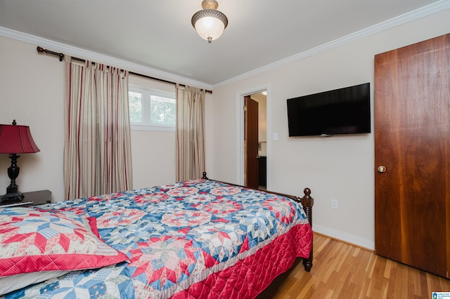 bedroom with crown molding and light hardwood / wood-style flooring