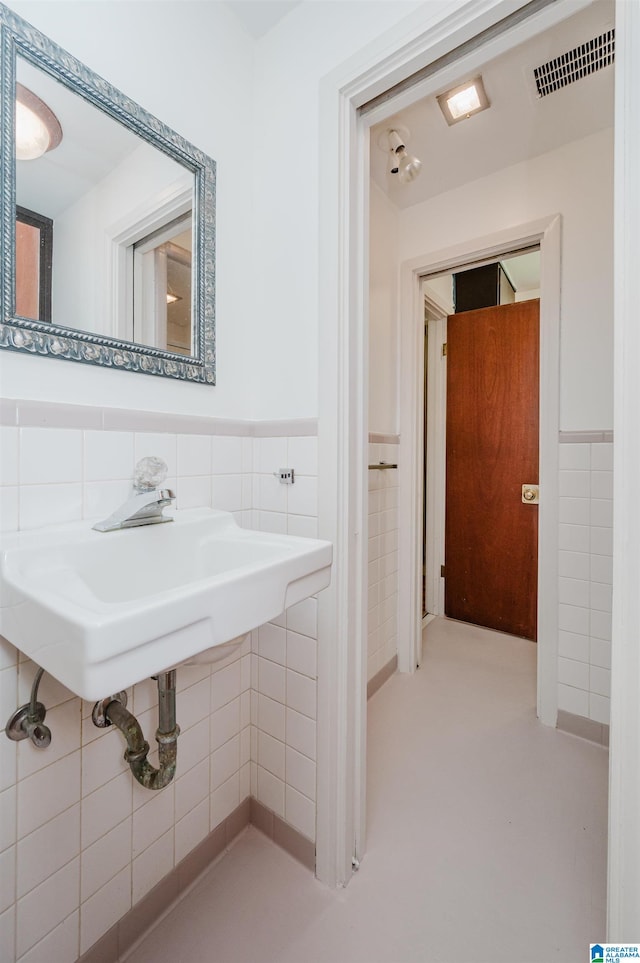 bathroom featuring tile walls and tasteful backsplash