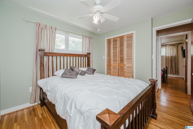 bedroom with a closet, light wood-type flooring, and ceiling fan