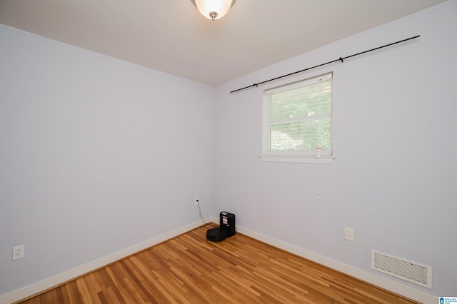 spare room with hardwood / wood-style floors