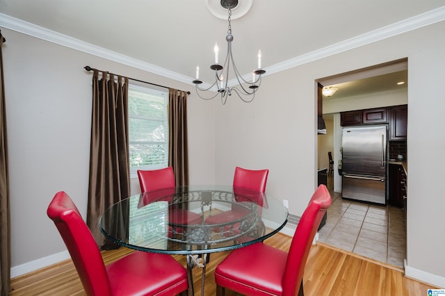 dining room featuring a chandelier, light tile patterned floors, and crown molding