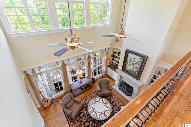 living room featuring light wood-type flooring, ceiling fan, and a wealth of natural light