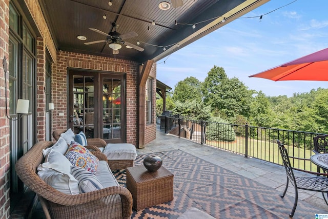 view of patio / terrace with a balcony, outdoor lounge area, and ceiling fan