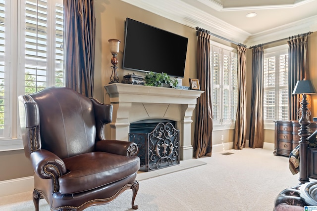 sitting room with carpet flooring and crown molding