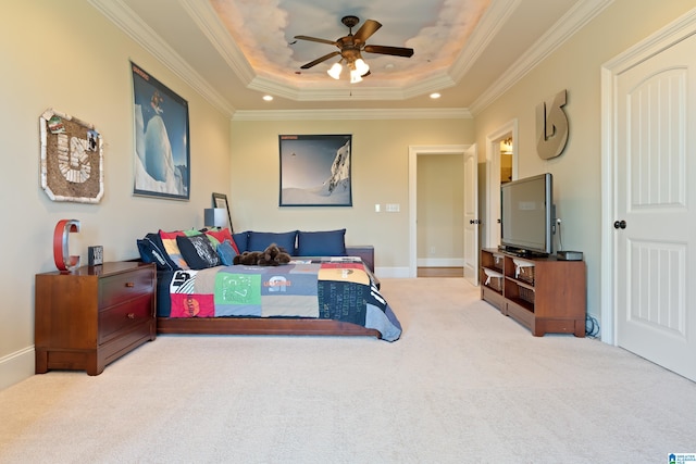 carpeted bedroom featuring ornamental molding, ceiling fan, and a tray ceiling