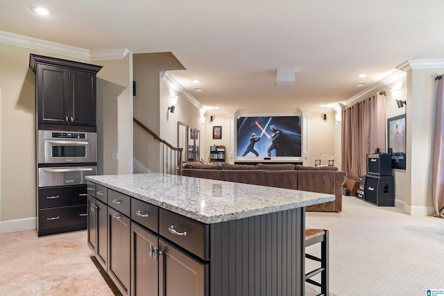 kitchen featuring a center island, light carpet, light stone countertops, and crown molding