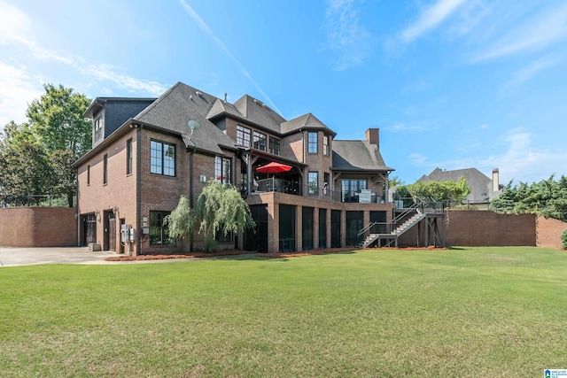 rear view of property featuring a yard