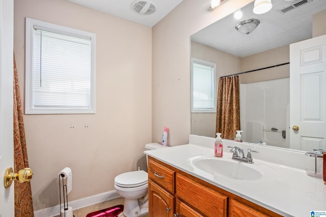 bathroom featuring visible vents, toilet, vanity, and curtained shower