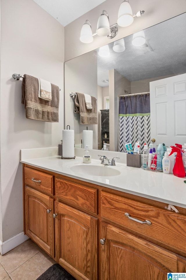 bathroom featuring a shower with curtain, tile patterned flooring, and vanity