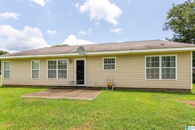 back of house featuring a lawn and a patio area