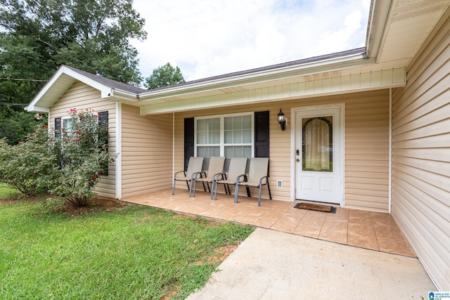 view of exterior entry with a porch