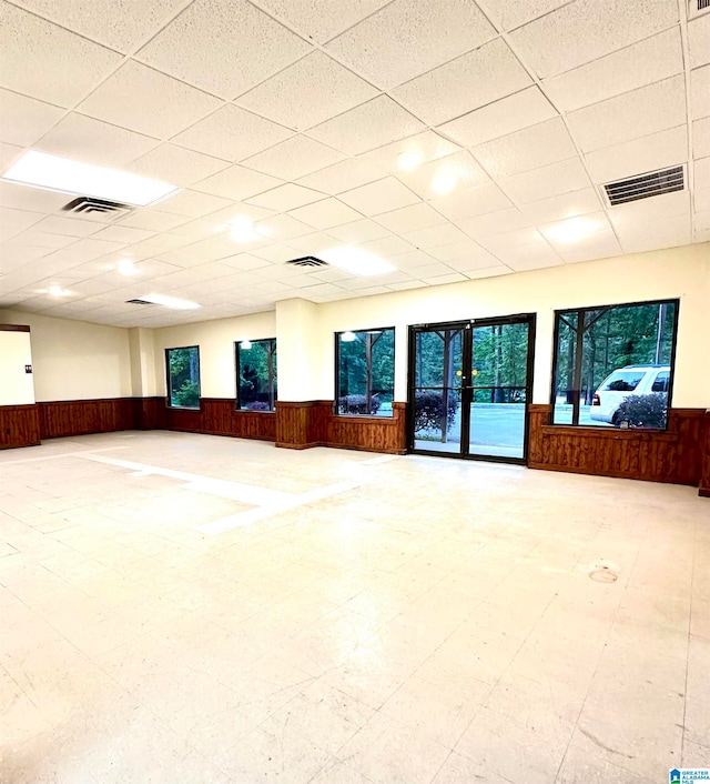 unfurnished room featuring a drop ceiling and light tile patterned floors