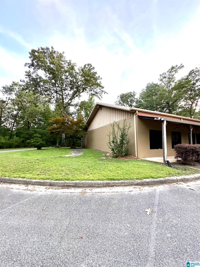 view of side of property with a lawn