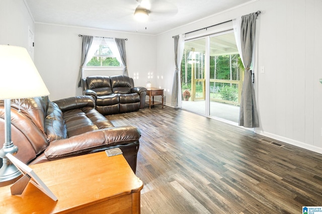 living room with crown molding, ceiling fan, and wood-type flooring