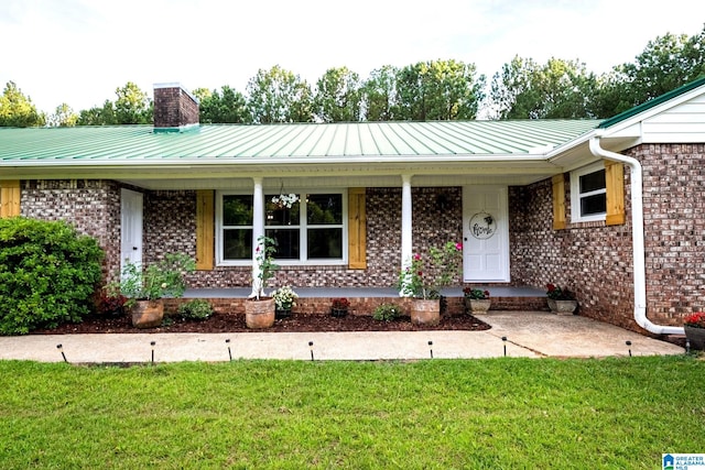 single story home featuring a porch and a front lawn