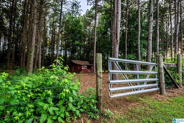 view of gate with a storage shed