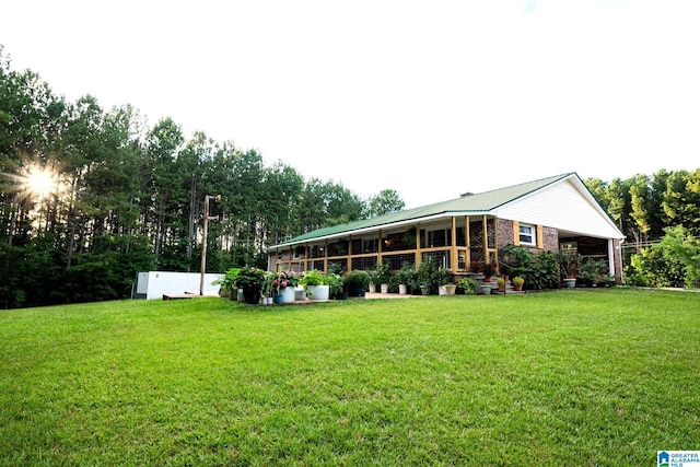 rear view of property featuring a yard