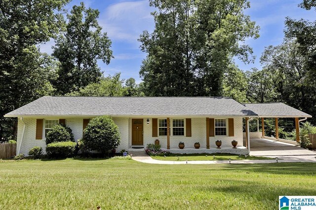 ranch-style house with a carport and a front yard