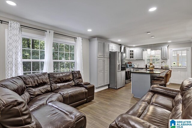 dining space featuring ornamental molding, ceiling fan with notable chandelier, and hardwood / wood-style flooring