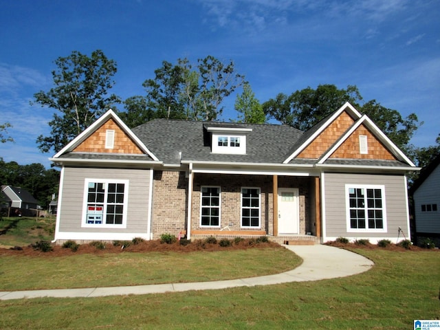 craftsman inspired home with a front lawn