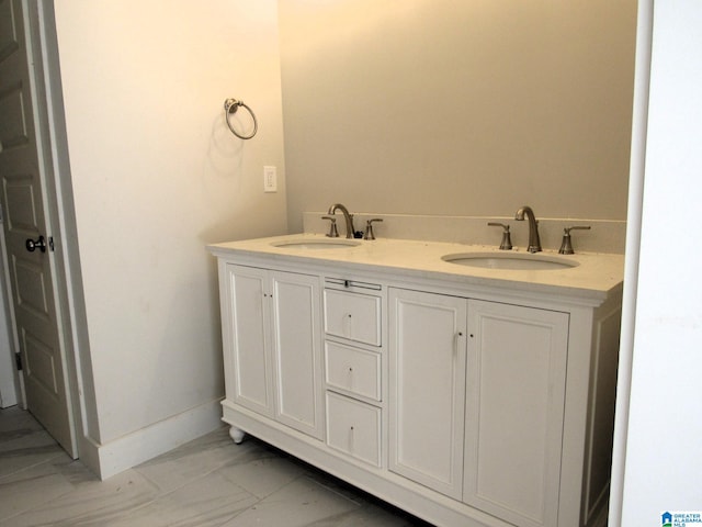 bathroom with dual bowl vanity and tile patterned flooring