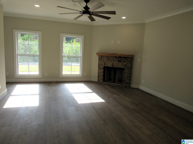 unfurnished living room featuring ceiling fan, a fireplace, ornamental molding, and hardwood / wood-style flooring