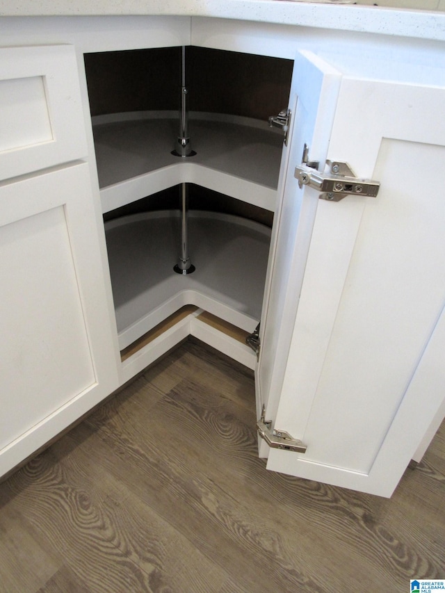 interior details featuring white cabinets and dark hardwood / wood-style flooring