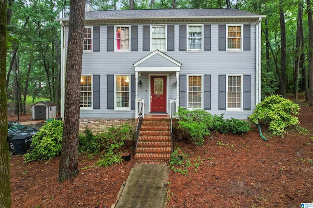 colonial house with a storage unit