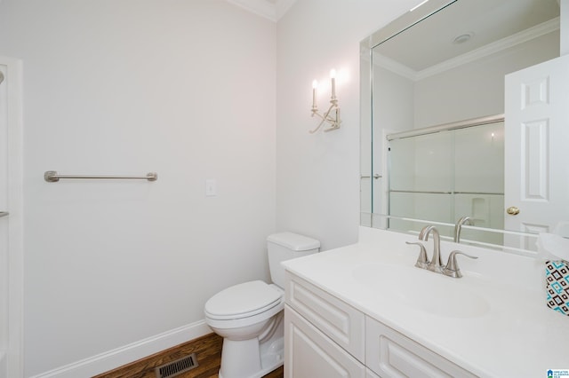 bathroom featuring wood-type flooring, vanity, toilet, walk in shower, and ornamental molding