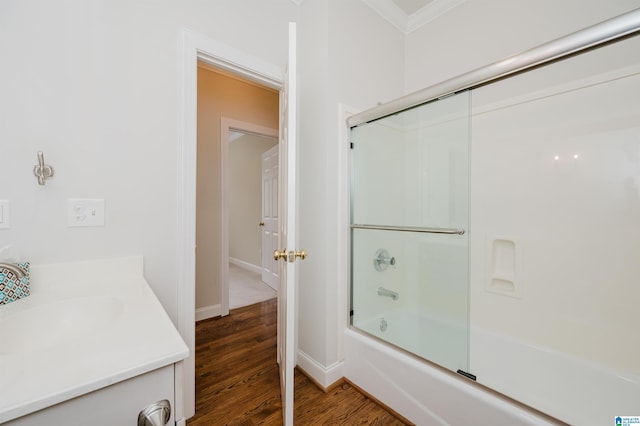 bathroom featuring bath / shower combo with glass door, vanity, and hardwood / wood-style flooring