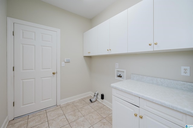 laundry area featuring light tile patterned floors, hookup for a washing machine, and cabinets