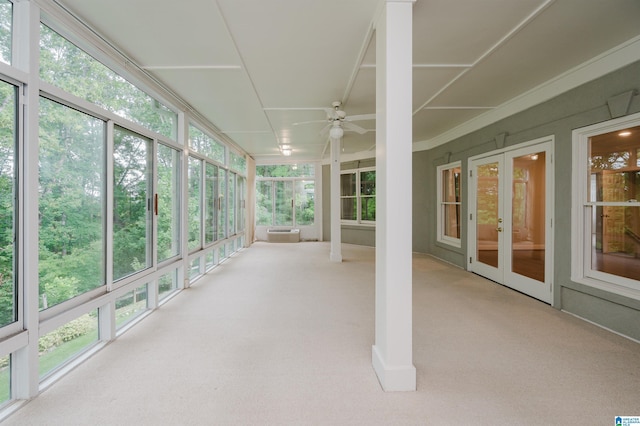 unfurnished sunroom with ceiling fan and a wealth of natural light