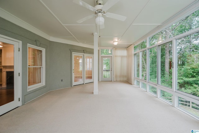 unfurnished sunroom with ceiling fan