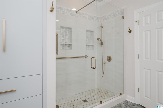 bathroom featuring a shower with shower door