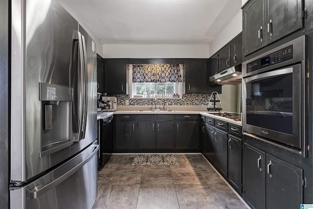 kitchen featuring stainless steel appliances, sink, and backsplash