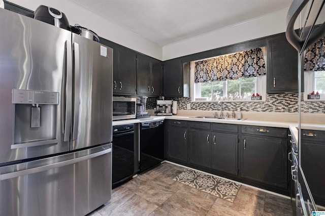 kitchen with light tile patterned floors, stainless steel appliances, tasteful backsplash, and sink