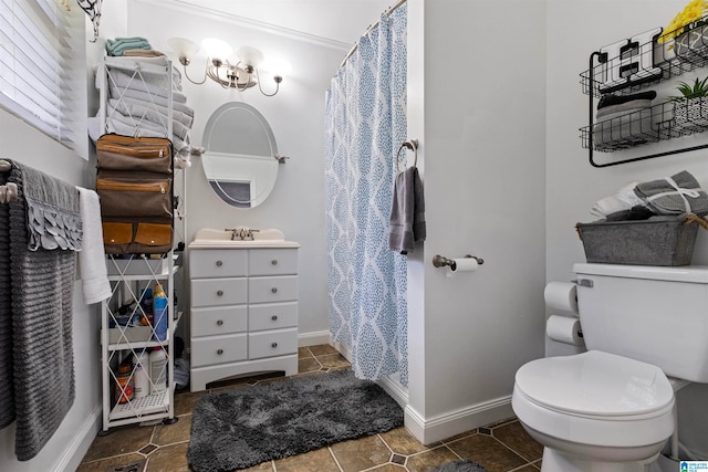 bathroom featuring vanity, tile patterned floors, crown molding, and toilet