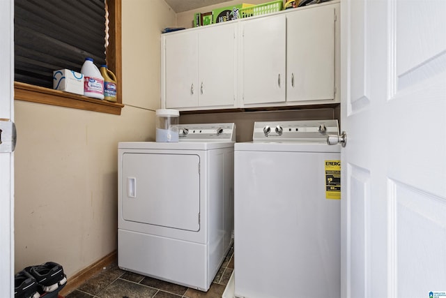 washroom featuring separate washer and dryer and cabinets