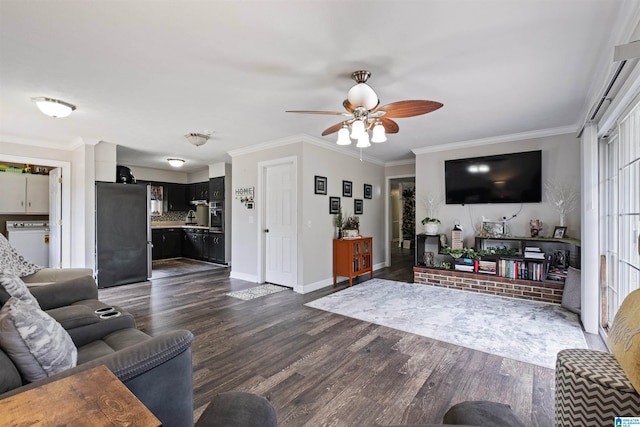 living room featuring washer / dryer, crown molding, dark wood-type flooring, and ceiling fan