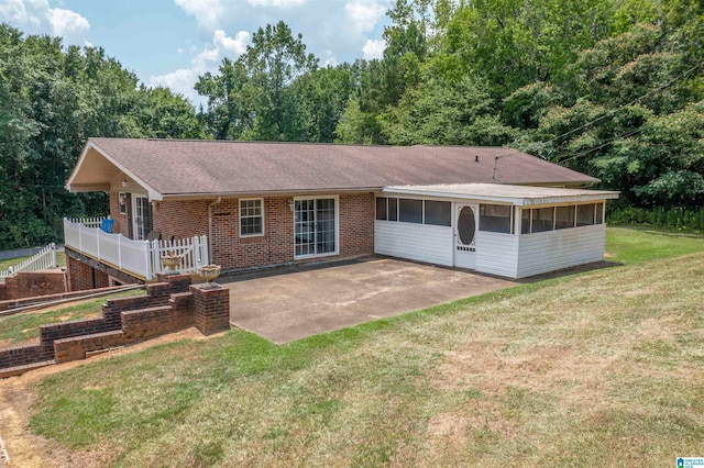 single story home with a patio, a sunroom, and a front lawn