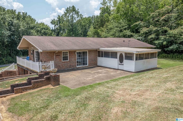 single story home with a sunroom, a patio area, and a front yard