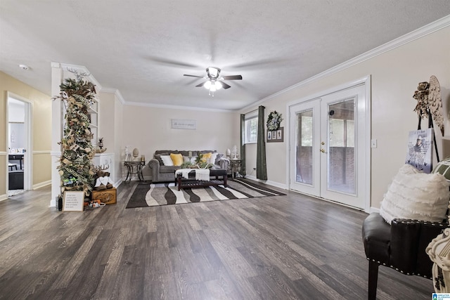 living room with ceiling fan, crown molding, dark wood-type flooring, a textured ceiling, and french doors