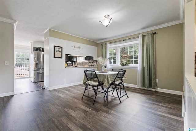 dining room with crown molding and hardwood / wood-style floors