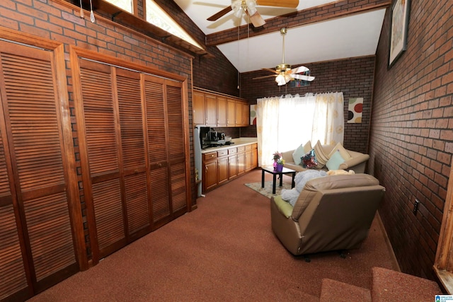 carpeted living room featuring ceiling fan, vaulted ceiling with beams, and brick wall