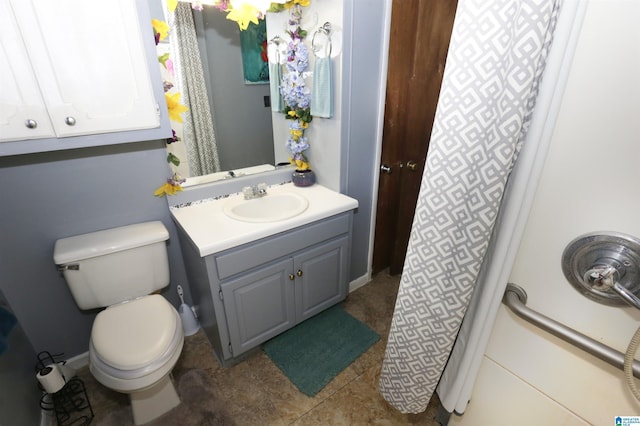 bathroom featuring toilet, vanity, and tile patterned floors