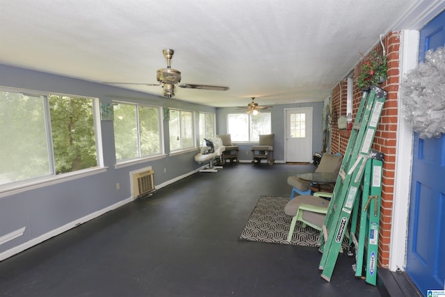 interior space with ceiling fan and heating unit