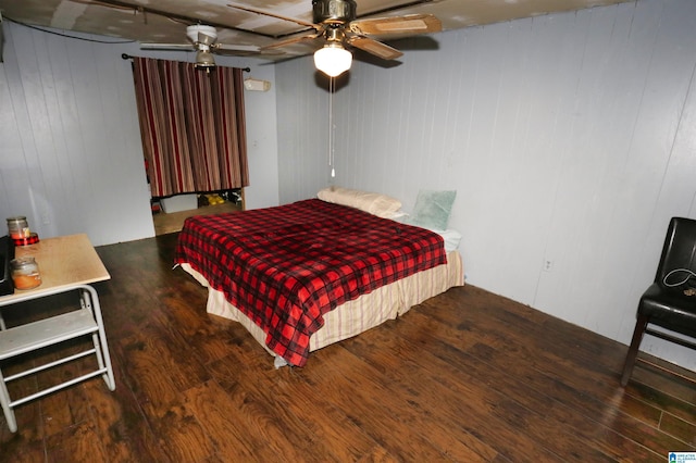 bedroom with ceiling fan and dark hardwood / wood-style flooring