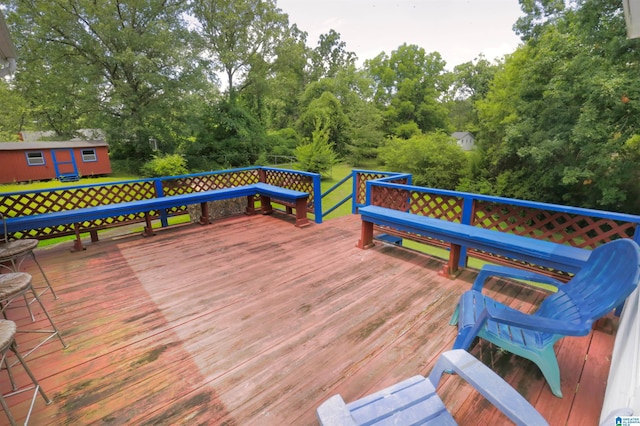 wooden terrace with a storage shed