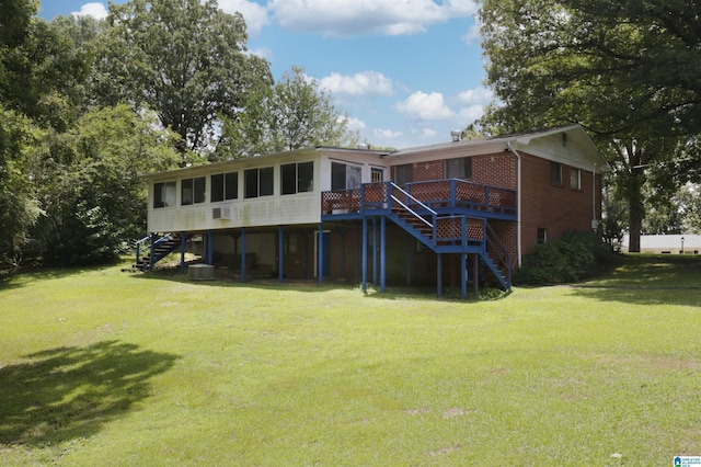 back of property with a deck and a lawn